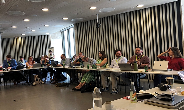 A photo shows participants seated in a square seating arrangment at the workshop 'Contesting the Far Right, Safeguarding Democracy: Comparative Insights from Europe and Latin America', organised by CEU's Democracy Institute and FES Democracy of the Future