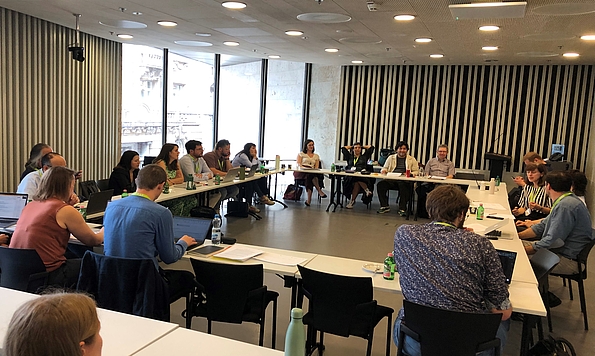 A photo shows participants seated in a square seating arrangment at the workshop 'Contesting the Far Right, Safeguarding Democracy: Comparative Insights from Europe and Latin America', organised by CEU's Democracy Institute and FES Democracy of the Future