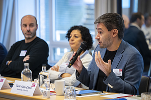 A photograph shows Anil Duman from Central European University, Jeroen Beirnaert from the International Trade Union Confederation, and Tarik Abou-Chadi from the University of Oxford at Brussels Democracy Dialogue 2025.